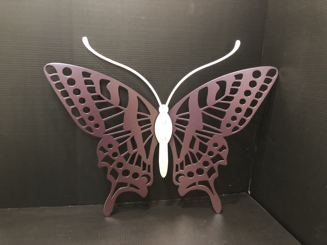 a purple and silver metal butterfly