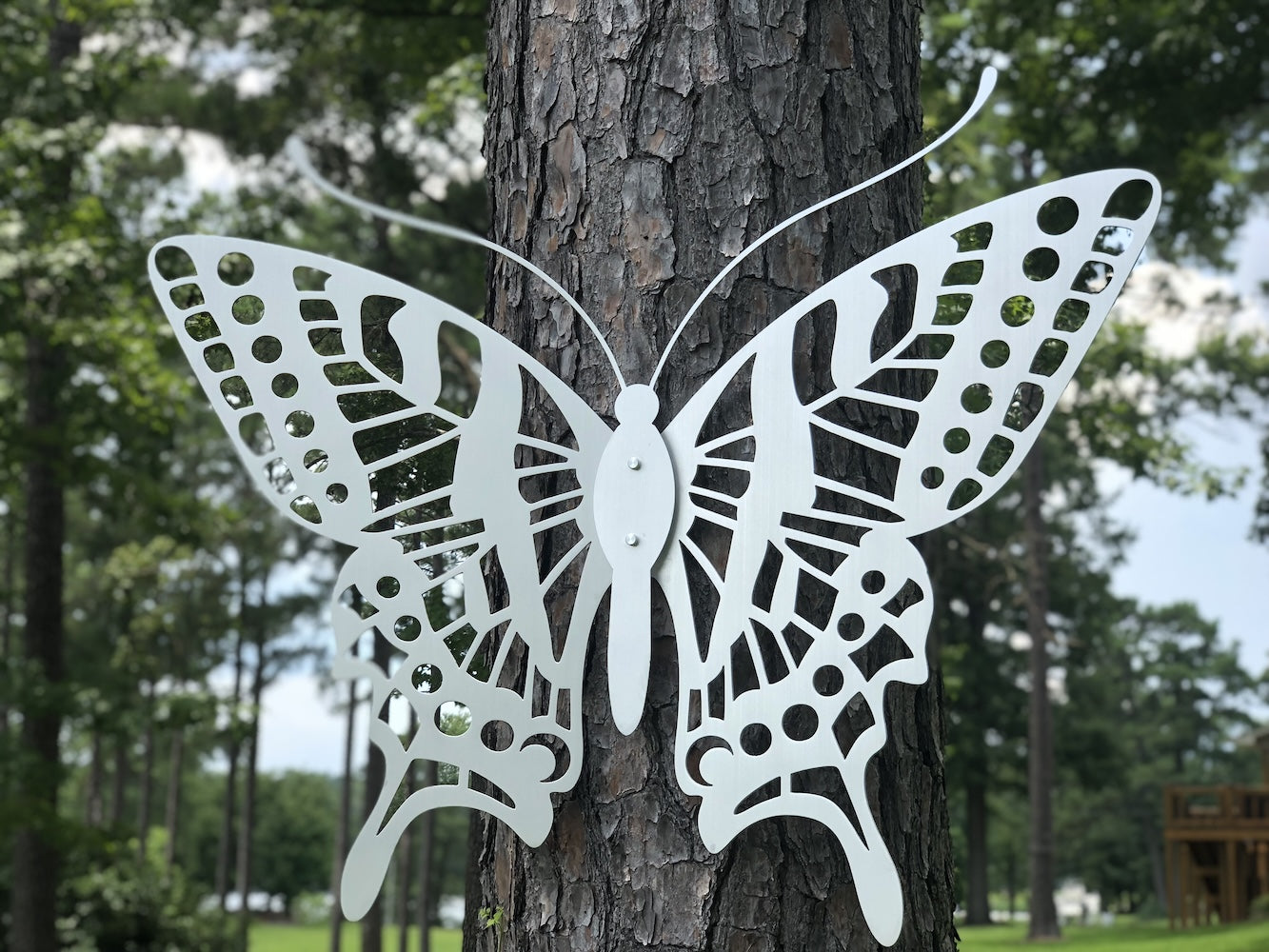 A metal buterfly on a tree