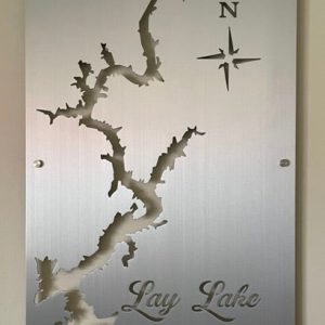 Lay Lake cutout metal map with compass rose on brushed silver, mounted on a light wall.