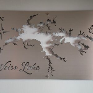 Weiss Lake metal map with compass rose, featuring intricate cutout design on brushed silver, mounted on a light wall.