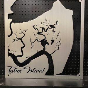 Tybee Island metal map with intricate cutout design, mounted on a black pegboard.