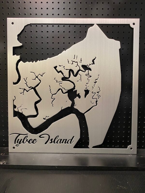 Tybee Island metal map with intricate cutout design, mounted on a black pegboard.