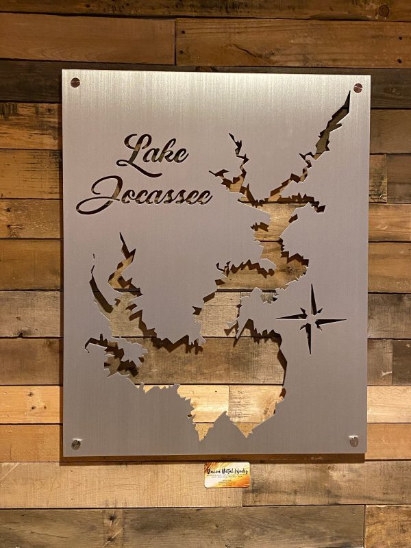 Lake Jocassee custom metal map with intricate cutout design and compass rose on wooden wall background.