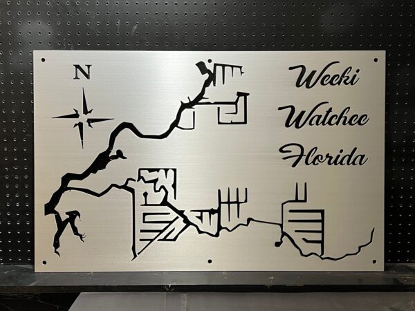 Weeki Wachee, Florida custom metal map with compass rose, featuring detailed cutouts, mounted on a black pegboard.