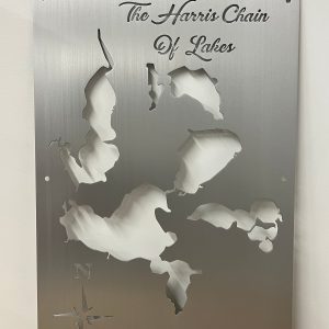 The Harris Chain of Lakes metal map with compass rose on brushed silver finish.