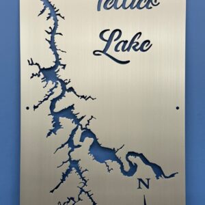 Tellico Lake metal map with compass rose, featuring cutout design on brushed silver, mounted on a blue wall.