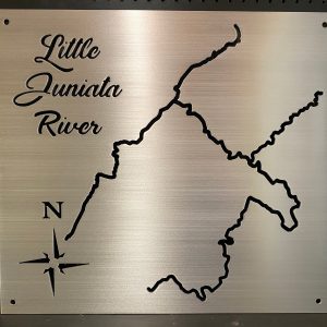 Little Juniata River metal map with compass rose, displayed on a black pegboard.