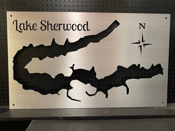 Lake Sherwood metal map with compass rose, cutout design on a brushed silver background, mounted on a black pegboard.