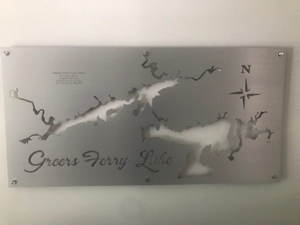 Metal map of Greers Ferry Lake with compass rose, mounted on a wall.