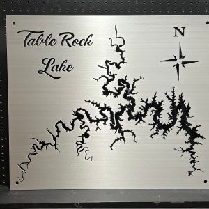 Table Rock Lake metal map with compass rose, featuring intricate cutout design on brushed silver, mounted on a pegboard.