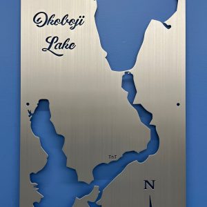 Okoboji Lake metal map with compass rose, featuring a brushed silver finish on a blue wall.