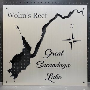 "Wolin's Reef Great Sacandaga Lake" metal map with compass design on a perforated black background.