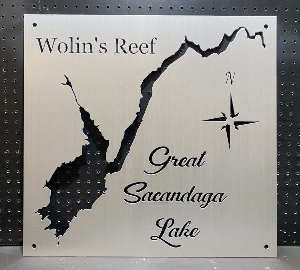 "Wolin's Reef Great Sacandaga Lake" metal map with compass design on a perforated black background.