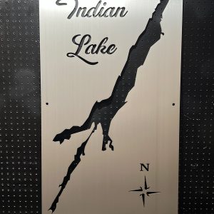 Metal map of Indian Lake with compass rose on a perforated black background.