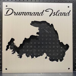 Custom Drummond Island metal map on a perforated black background.