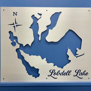 Lobdell Lake metal map with compass rose, mounted on a blue wall.