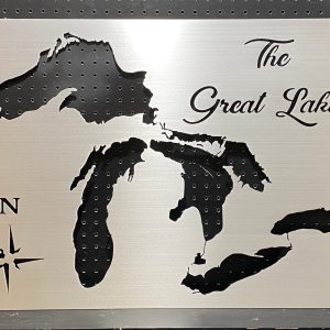 Great Lakes cutout map on brushed metal with "The Great Lakes" text and compass rose, mounted on a pegboard.