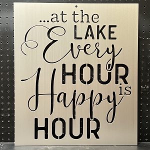 Metal sign with "at the lake every hour is happy hour" text in decorative script on a perforated background.