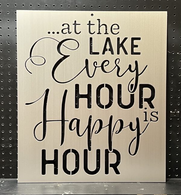 Metal sign with "at the lake every hour is happy hour" text in decorative script on a perforated background.