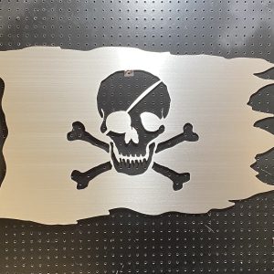 Metal pirate flag design with a skull and crossbones cutout, mounted on a black pegboard.