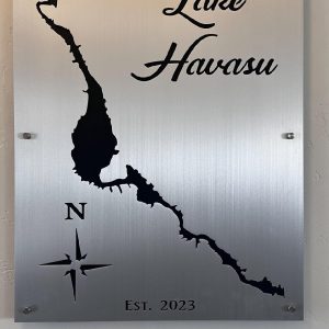 Lake Havasu metal sign with lake outline, compass rose, and "Est. 2023" on brushed metallic background.