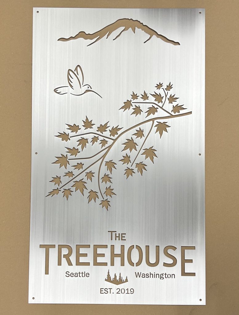 Custom metal sign with mountain, hummingbird, and maple leaves, reading "The Treehouse, Seattle, Washington, Est. 2019."