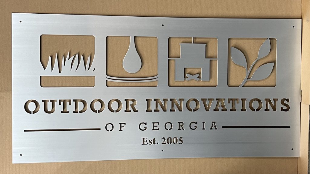 Outdoor Innovations of Georgia metal sign with nature-themed cutouts, established 2005.