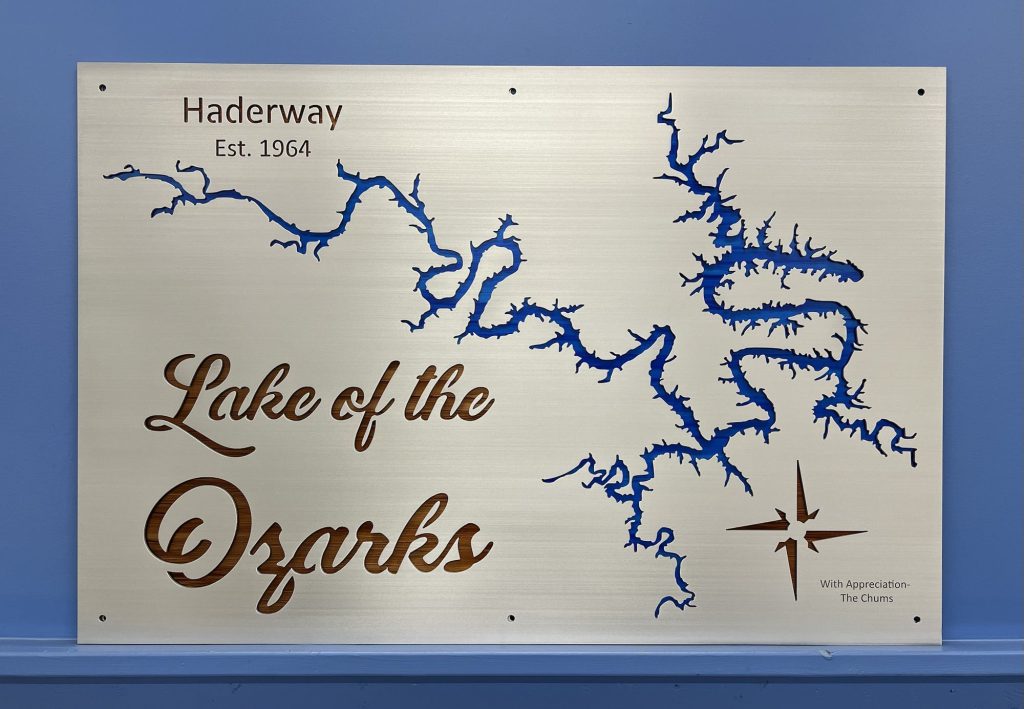 Lake of the Ozarks metal map with "Haderway Est. 1964" text, featuring a compass rose and blue detailing on a silver background.