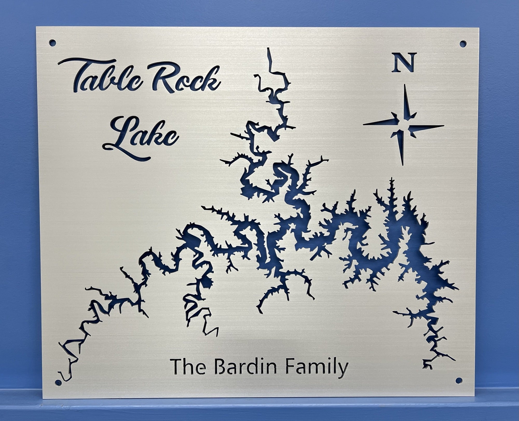 Table Rock Lake metal map with compass rose and "The Bardin Family" text, mounted on a blue wall.