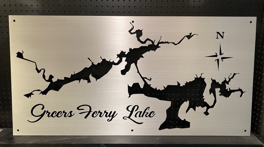 Greers Ferry Lake metal map with compass design on a perforated black background.