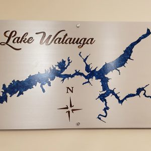 Metal map of Lake Watauga with compass design mounted on a wall.