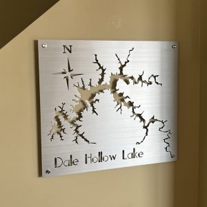 Metal map of Dale Hollow Lake with compass design on a brushed background, mounted on a wall.