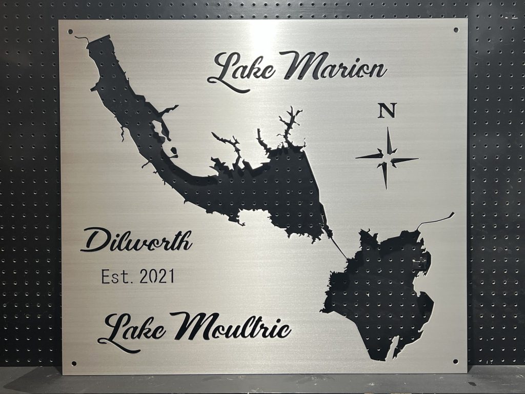 Metal sign featuring Lake Marion and Lake Moultrie, with compass rose and "Dilworth, Est. 2021" on perforated background.