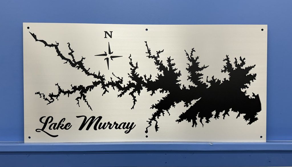 Lake Murray metal map with compass rose on a brushed background, mounted on a blue wall.