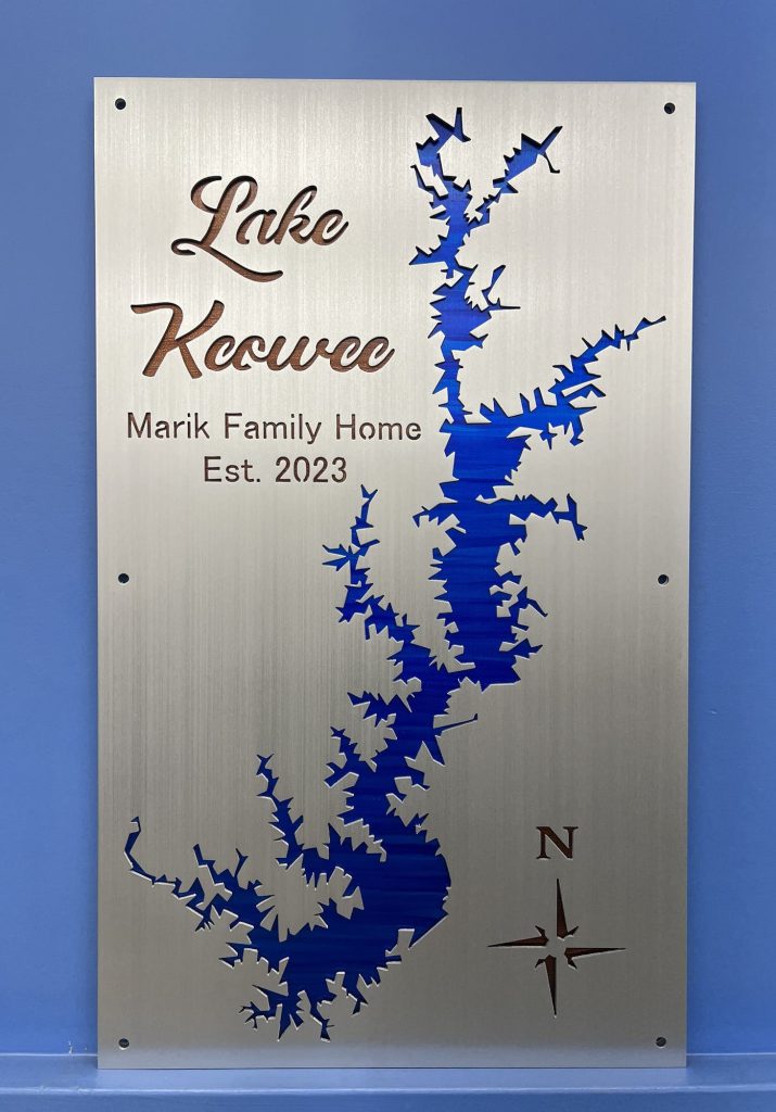 Lake Keowee metal sign for Marik Family Home, Est. 2023, with compass rose on a blue background.