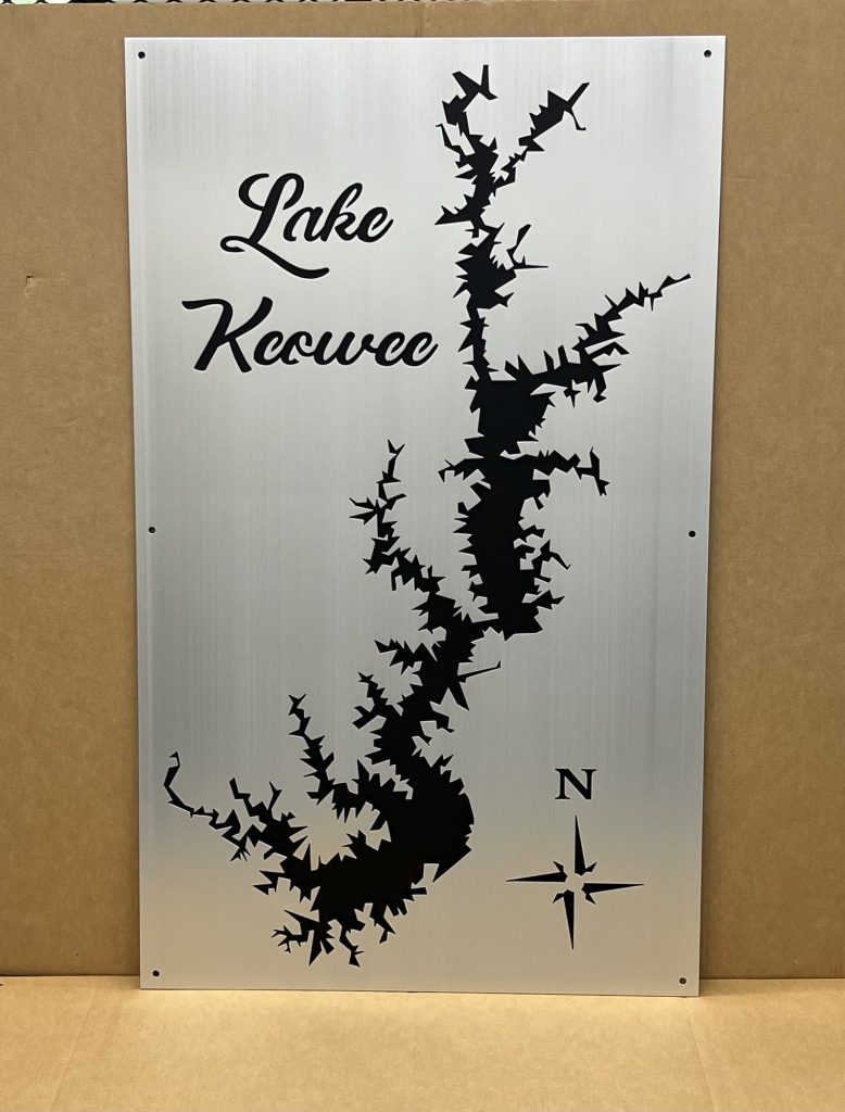 Lake Keowee custom metal map with black silhouette and compass rose on a brushed metallic background.