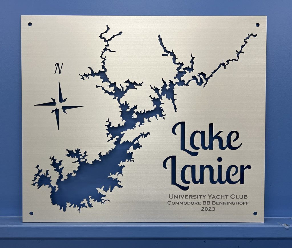 Lake Lanier metal map for University Yacht Club, Commodore BB Benninghoff, 2023, with compass rose on blue wall.