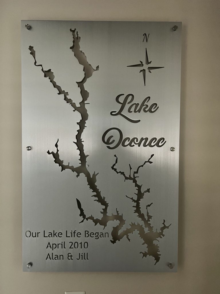 Lake Oconee custom metal map with compass rose, featuring "Our Lake Life Began April 2010, Alan & Jill" text.