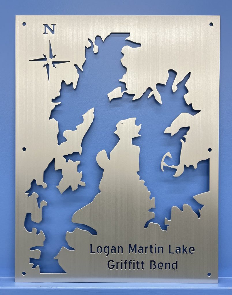 Logan Martin Lake metal map featuring "Griffitt Bend" and compass rose on brushed silver, mounted on a blue wall.