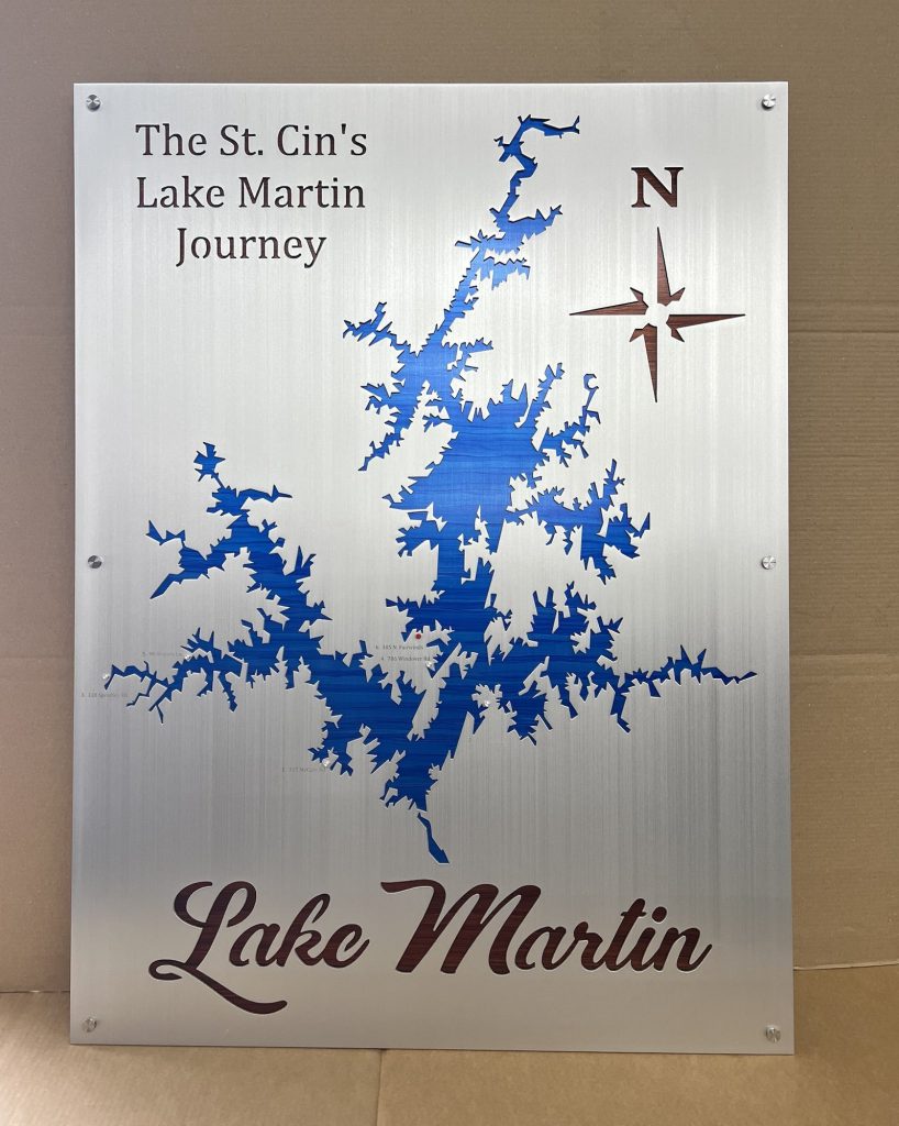 Custom Lake Martin metal map with "The St. Cin's Lake Martin Journey" text and compass rose on brushed metal.