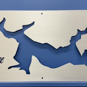Lake Powell map cutout on metal, featuring a compass rose and decorative text, mounted on a blue wall.